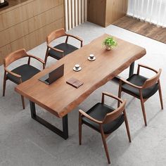 a wooden table with black chairs around it