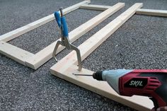 a pair of pliers are being used to attach wooden planks on the ground