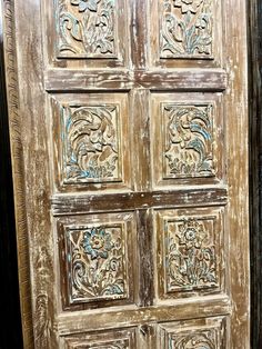 an old wooden door with decorative carvings on it