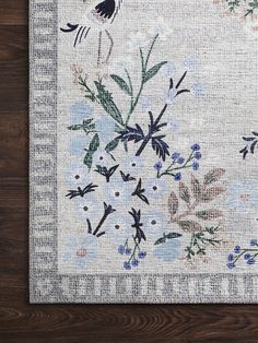 a rug with flowers and birds on it