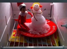 an elf and snowman are in the fridge together for some fun time with each other