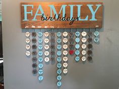 a wooden sign that says family birthday hanging on the wall next to a key holder