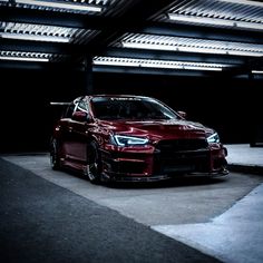 a red car parked in a parking garage