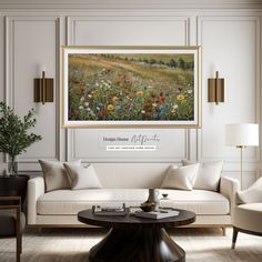 a living room filled with furniture and a painting on the wall above it's coffee table