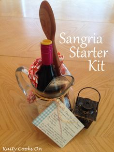 a bottle of wine sitting on top of a table next to a wooden spoon and other items