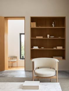 a living room filled with furniture and a book shelf