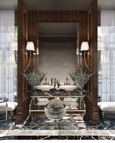 a bathroom with two sinks, mirrors and marble counter tops in front of the mirror