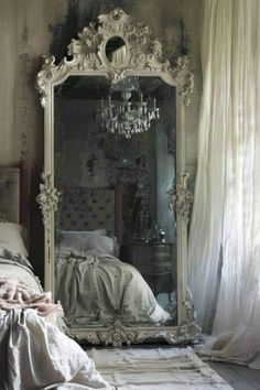 a bedroom with a large mirror on the wall