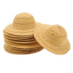 several straw hats stacked on top of each other