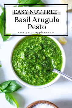 basil pesto in a white bowl with text overlay that reads easy nut - free basil arugula pesto