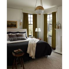 a bedroom with a large bed and two lamps on either side of the window sill