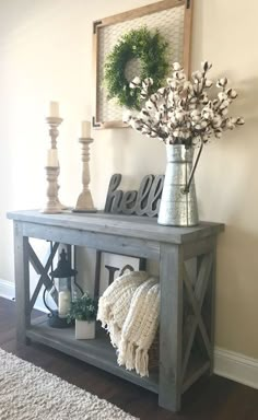 a wooden table with flowers and candles on top