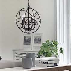 a dining room table with chairs and a chandelier hanging from the ceiling