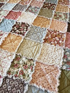 an old quilt that has been made into a bed spread with many different colors and patterns