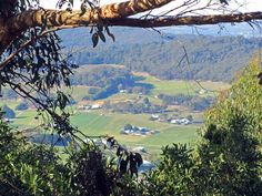 a view from the top of a hill looking down on a valley and town below