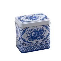 a blue and white box with flowers on the lid is sitting in front of a white background