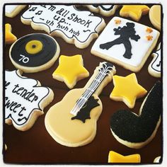 decorated cookies are arranged in the shape of guitar, violin, and other musical instruments