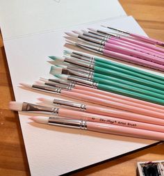 there are many different colored pencils on the table