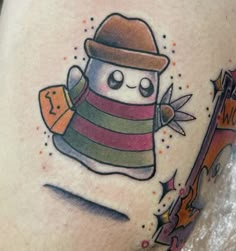 a tattoo with a snowman wearing a hat and scarf on it's thigh