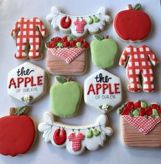 decorated cookies are arranged in the shape of apples, apple pies and other items