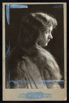 black and white photograph of a woman with long hair looking off to the side in profile