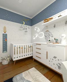 a baby's room with white furniture and stars on the wall, including a crib