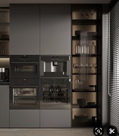 a modern kitchen with stainless steel appliances and glass doors on the wall, along with shelves filled with wine glasses