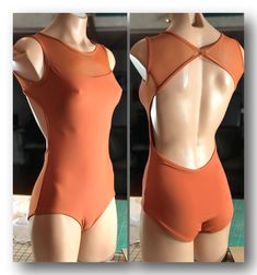 a mannequin wearing an orange swimsuit in front of a mirror with its back turned to the camera