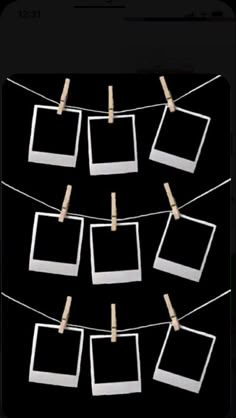 several polaroid frames hanging from clothes pins on a line with clothes pins attached to them