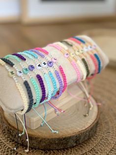 a pair of sandals that are on top of a wooden board with beads and eyeballs