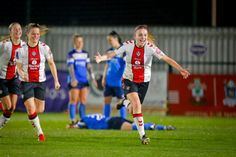 the women's soccer team is running after the ball