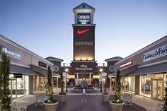 the entrance to a shopping center at dusk