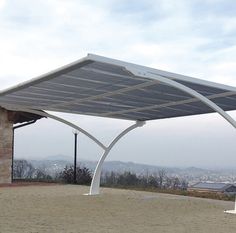 a large white awning sitting on top of a brick patio next to a building