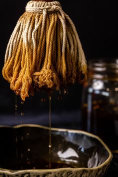 a bowl with some kind of liquid pouring out of it to make something look like cornrows