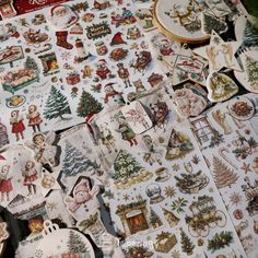 many christmas stickers are laid out on the table with other decorations and ornaments around them