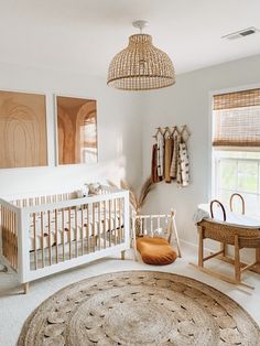 a baby's room with white walls and furniture