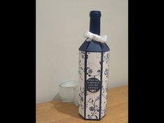 a wine bottle that is sitting on a table with a bow around it's neck