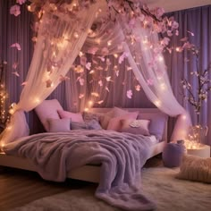 a bed with pink pillows and lights on the headboard, in front of a purple curtain