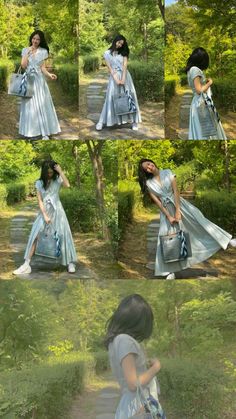 a woman in a blue dress is walking through the woods