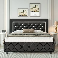 a bed with black leather headboard and foot board