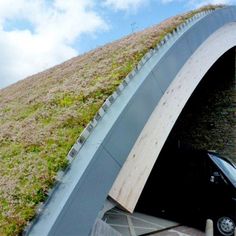 a car is parked in front of a green roof