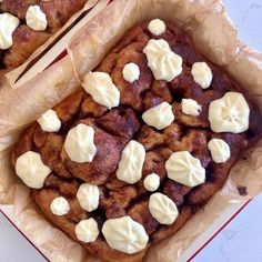 two pieces of bread with marshmallows on top in a red and white box