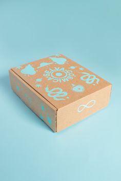 an open box on a blue background with animals and symbols painted on it's sides