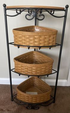 three baskets are stacked on top of each other in a corner shelf next to a door