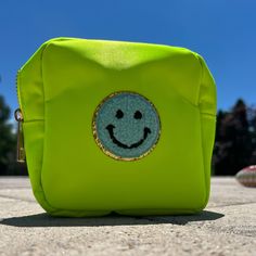 Choose from Lime OR Pink - Hot pink with pink smile patch OR lime green with blue smile patch -Zipper pouch perfect for holding jewelry, traveling, or anything you can think of! - This 5 inch square pouch is 2 inches wide inside. 100% nylon outside and 100% polyester lining inside with gold zipper detail. FREE shipping when you spend $40 or more! Trendy Green Bag For Personal Use, Green School Pouch, Green Rectangular Cosmetic Bag For School, Trendy Green Cosmetic Bag With Removable Pouch, Trendy Green Everyday Cosmetic Bag, Trendy Green Travel Cosmetic Bag, Green Rectangular School Pouch, Cute Green Travel Pouch, Green Zipper Pouch For School