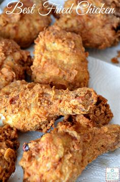 some fried chicken is sitting on a white paper towel with the words best fried chicken