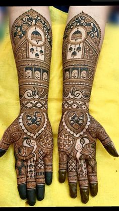 two hands with henna designs on them