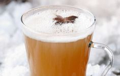 a cup of beer sitting on top of snow covered ground