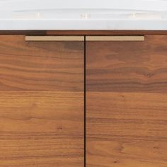 a white sink sitting on top of a wooden cabinet