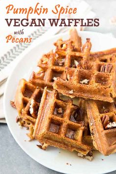 pumpkin spice vegan waffles with pecans on a white plate, ready to be eaten